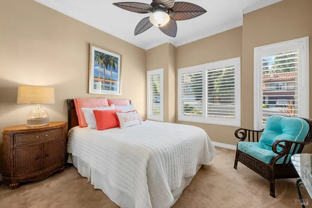 a view of a backyard with table and chairs under an umbrella