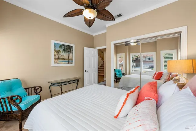 a front view of a house with a potted plant