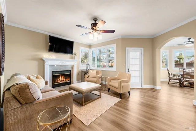a living room with furniture a flat screen tv and a fireplace