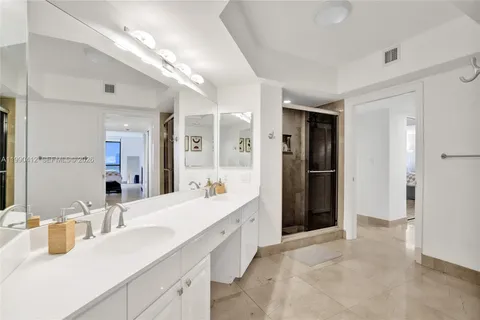 a bathroom with a double vanity sink mirror and double