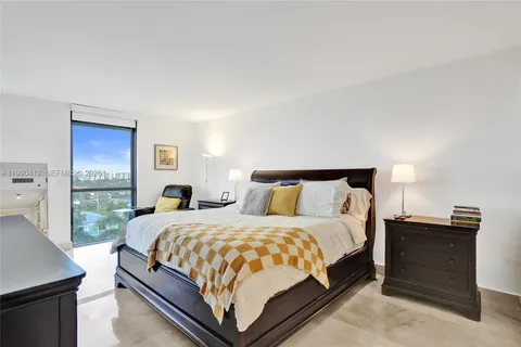 a bedroom with a bed and a night stand