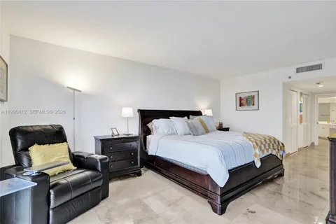 a bedroom with a bed and chair