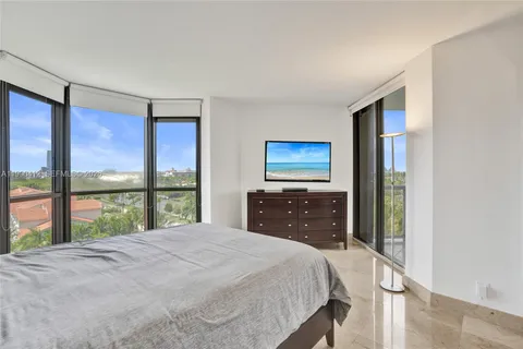 a bedroom with a large bed and a large window