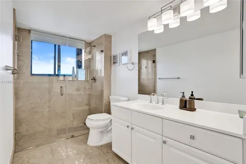 a bathroom with a double vanity sink mirror and toilet