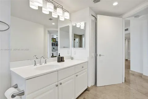 a bathroom with a sink vanity and a mirror