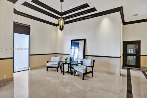 a hallway with chairs and a projector on a dresser