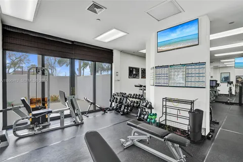 a room with gym equipment and floor to ceiling window
