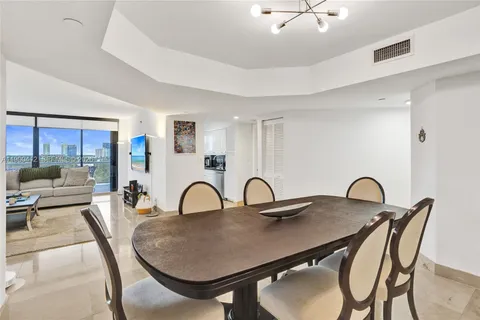 a dining room with furniture and chandelier