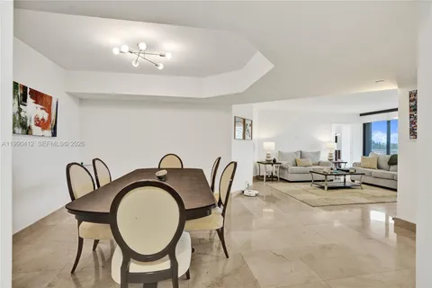 a living room with furniture a chandelier and a painting