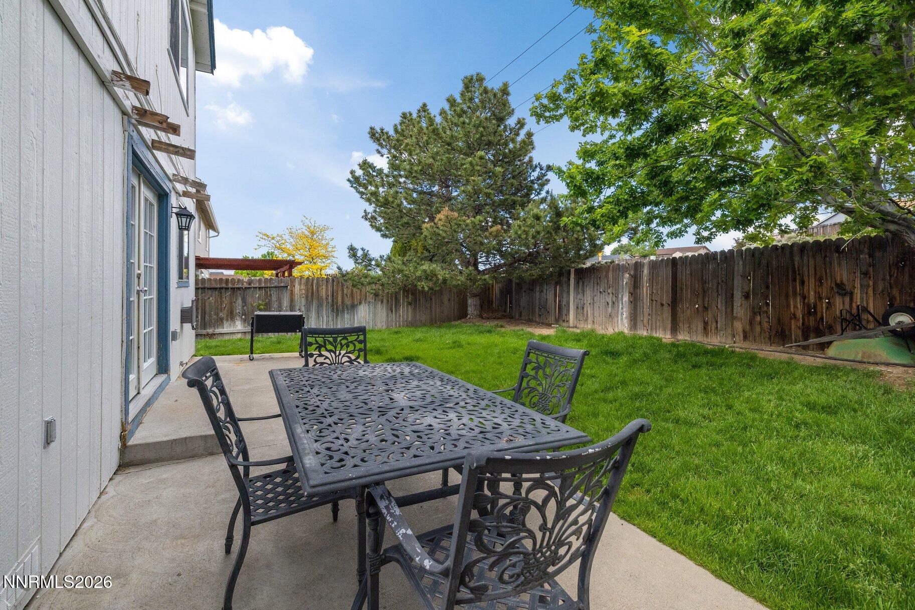 8486 Piper Place Reno, NV 89506 - Photo 34 of 80 a view of outdoor sitting area with furniture and wooden fence