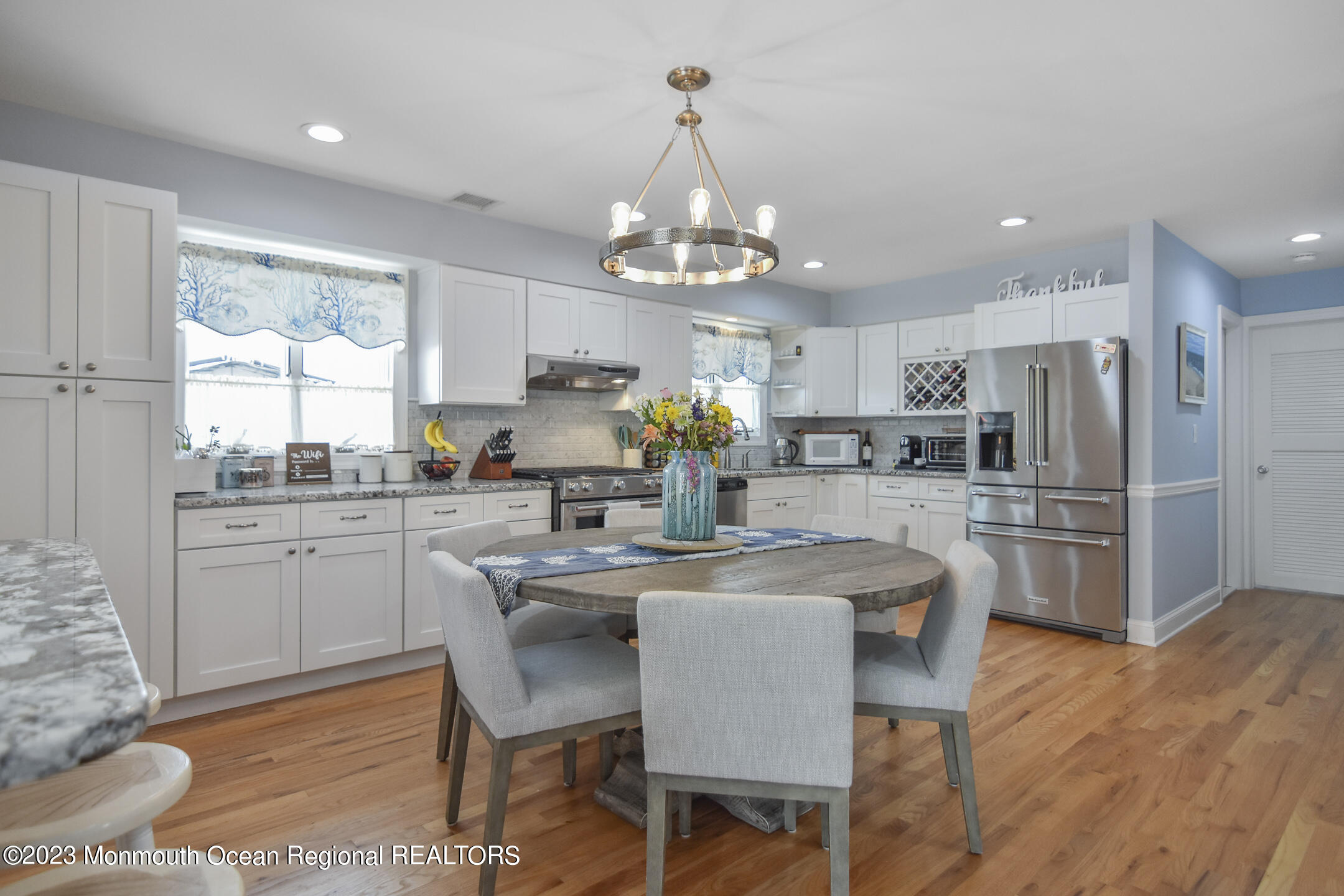8 Rochester Drive Brick, NJ 08723 - Photo 7 of 41 a kitchen with stainless steel appliances granite countertop a dining table chairs refrigerator and cabinets