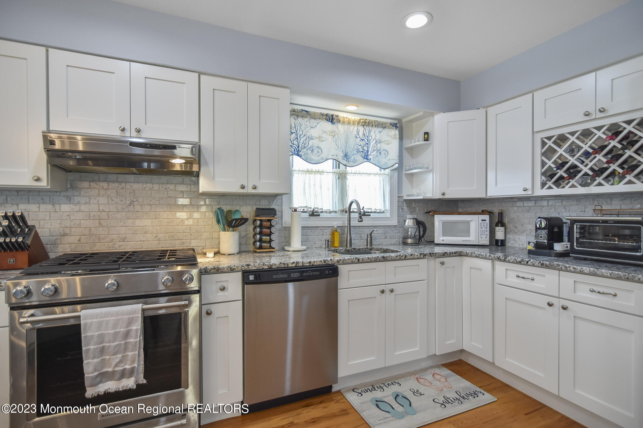 8 Rochester Drive Brick, NJ 08723 - Photo 8 of 41 a kitchen with stainless steel appliances granite countertop a stove a sink dishwasher and cabinets with wooden floor