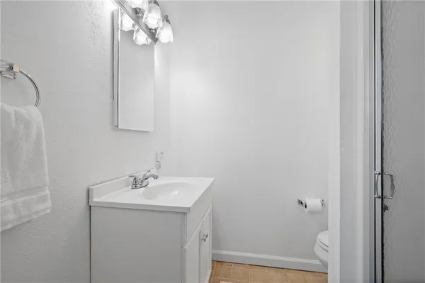 a bathroom with a sink a light fixture and a mirror