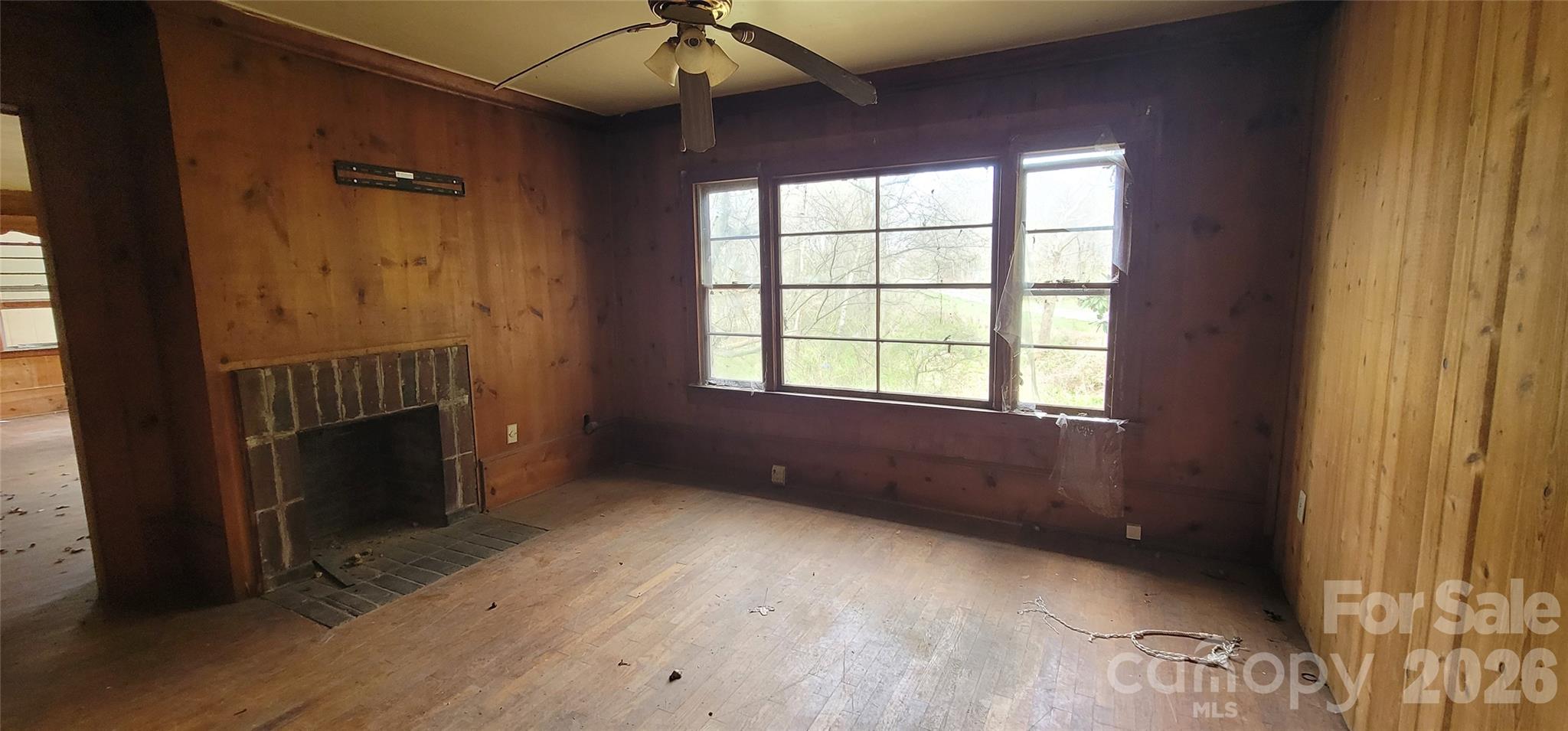 1939 River Road Lincolnton, NC 28092 - Photo 5 of 23 a view of an empty room with a fireplace and a window