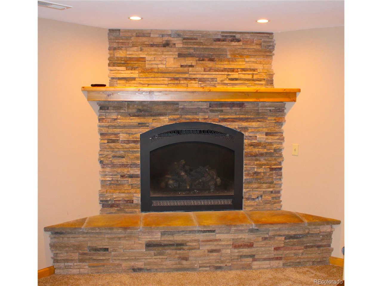 946 Singletree Road Hartsel, CO 80449 - Photo 35 of 50 Custom Built Propane Heat Fireplace with Stone Hearth and Wooden Mantle.