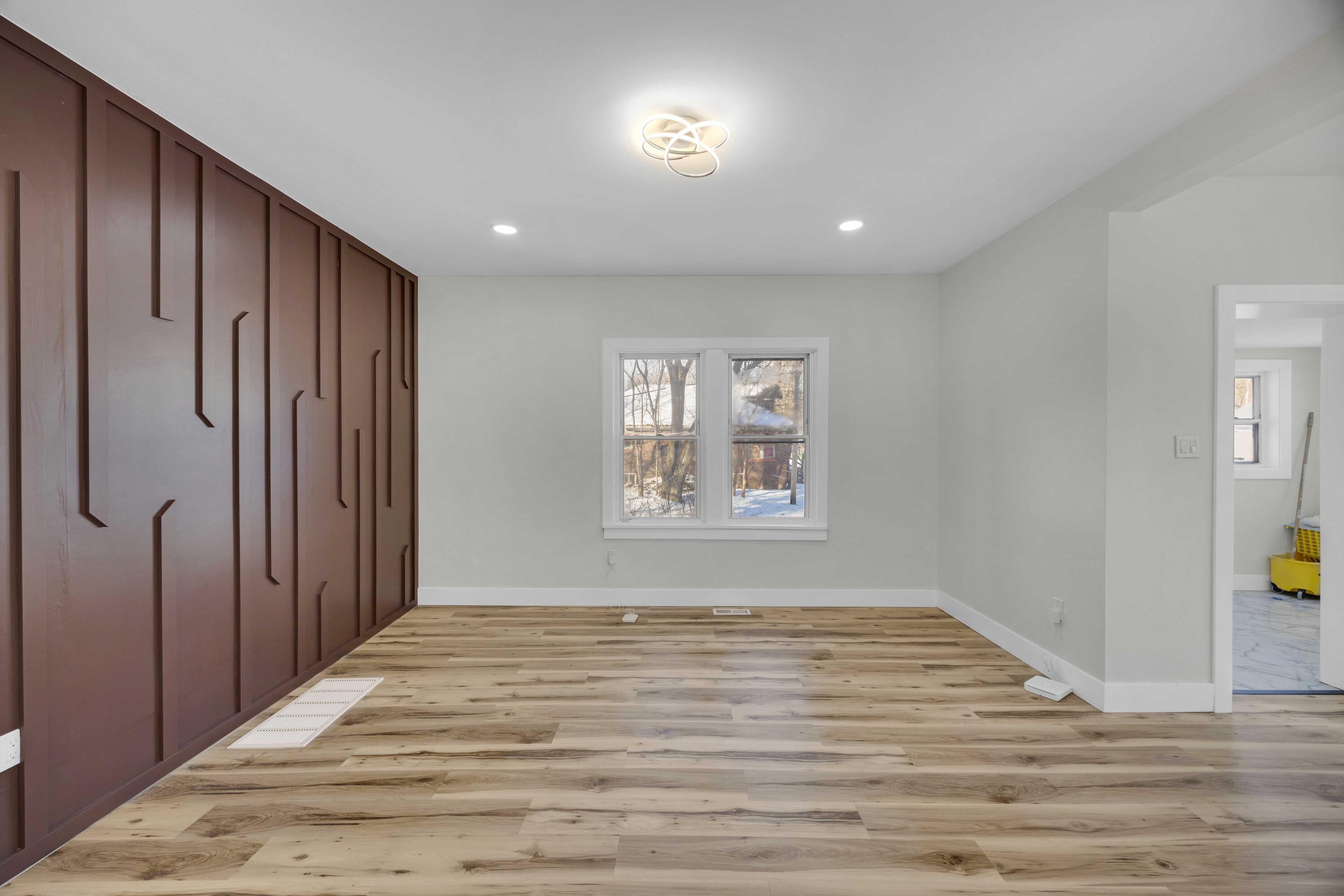 4200 Monroe Street Gary, IN 46408 - Photo 8 of 25 a view of an empty room with wooden floor and a window