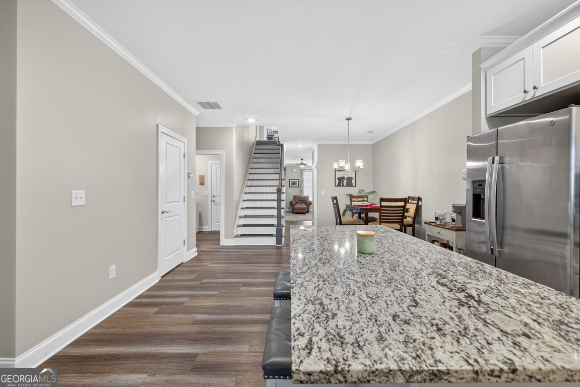110 Magnolia Place Homer, GA 30547 - Photo 12 of 42 a kitchen with stainless steel appliances kitchen island granite countertop a refrigerator and stove