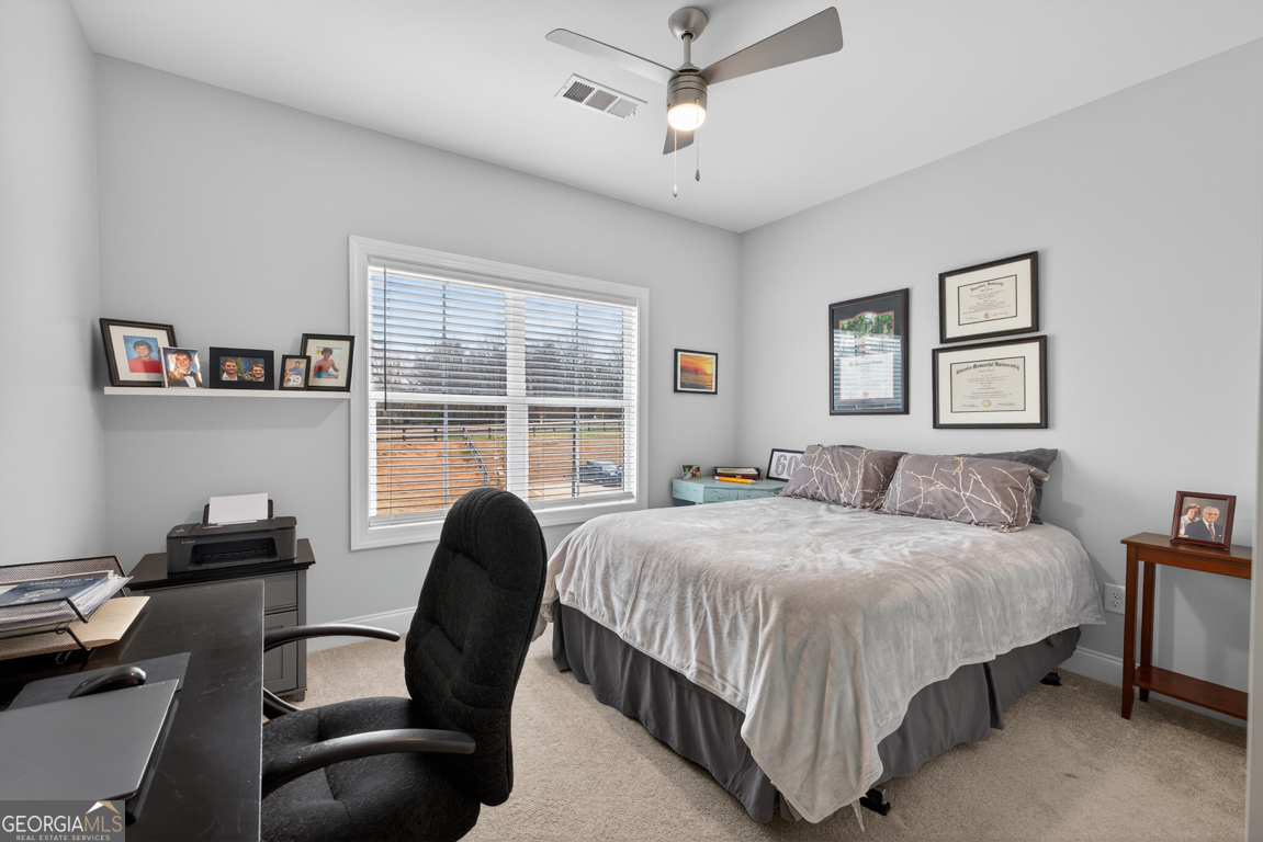 110 Magnolia Place Homer, GA 30547 - Photo 27 of 42 a bedroom with a bed and a chair