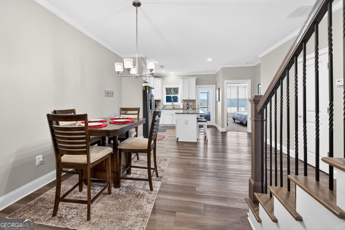 110 Magnolia Place Homer, GA 30547 - Photo 7 of 42 a view of a dining room and livingroom with furniture wooden floor a chandelier