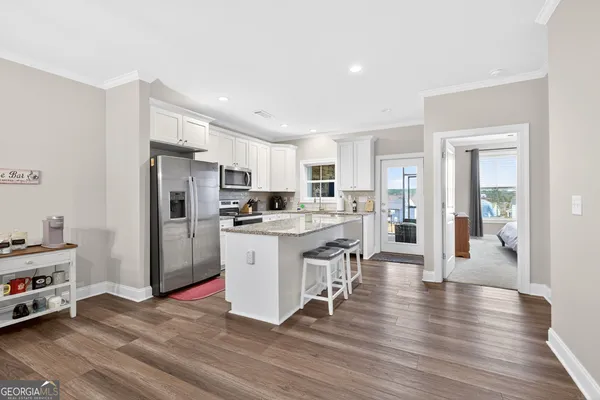 a kitchen with white cabinets and stainless steel appliances