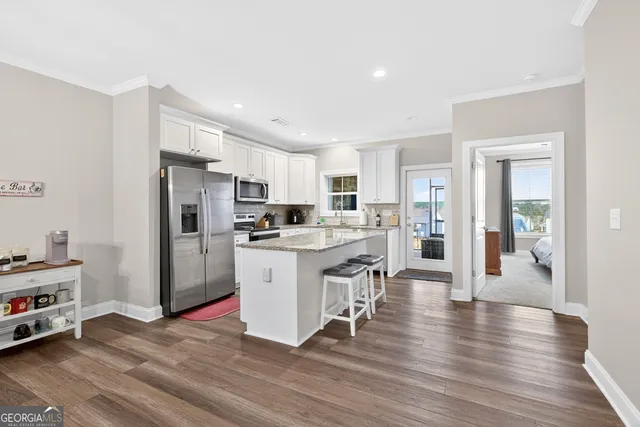 a kitchen with white cabinets and stainless steel appliances