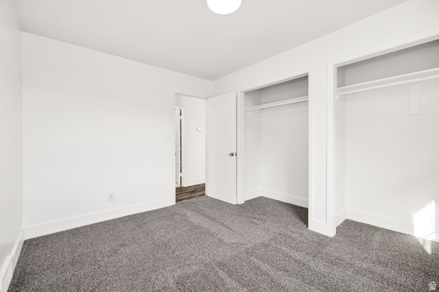 4155 Johnson Road Nibley, UT 84321 - Photo 22 of 71 Unfurnished bedroom with dark colored carpet and two closets
