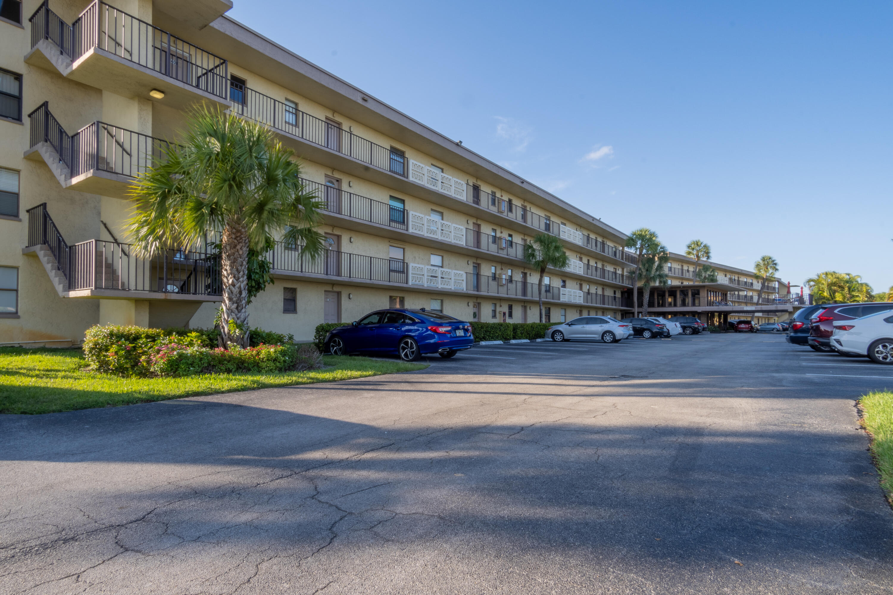 9355 Southwest 8th Street, Unit 406 Boca Raton, FL 33428 - Photo 1 of 22 a front view of building with cars parked