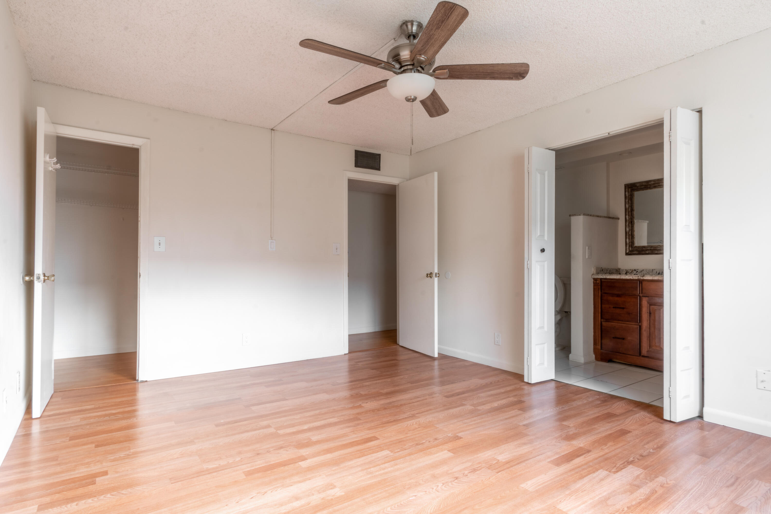 9355 Southwest 8th Street, Unit 406 Boca Raton, FL 33428 - Photo 12 of 22 a view of an empty room with wooden floor