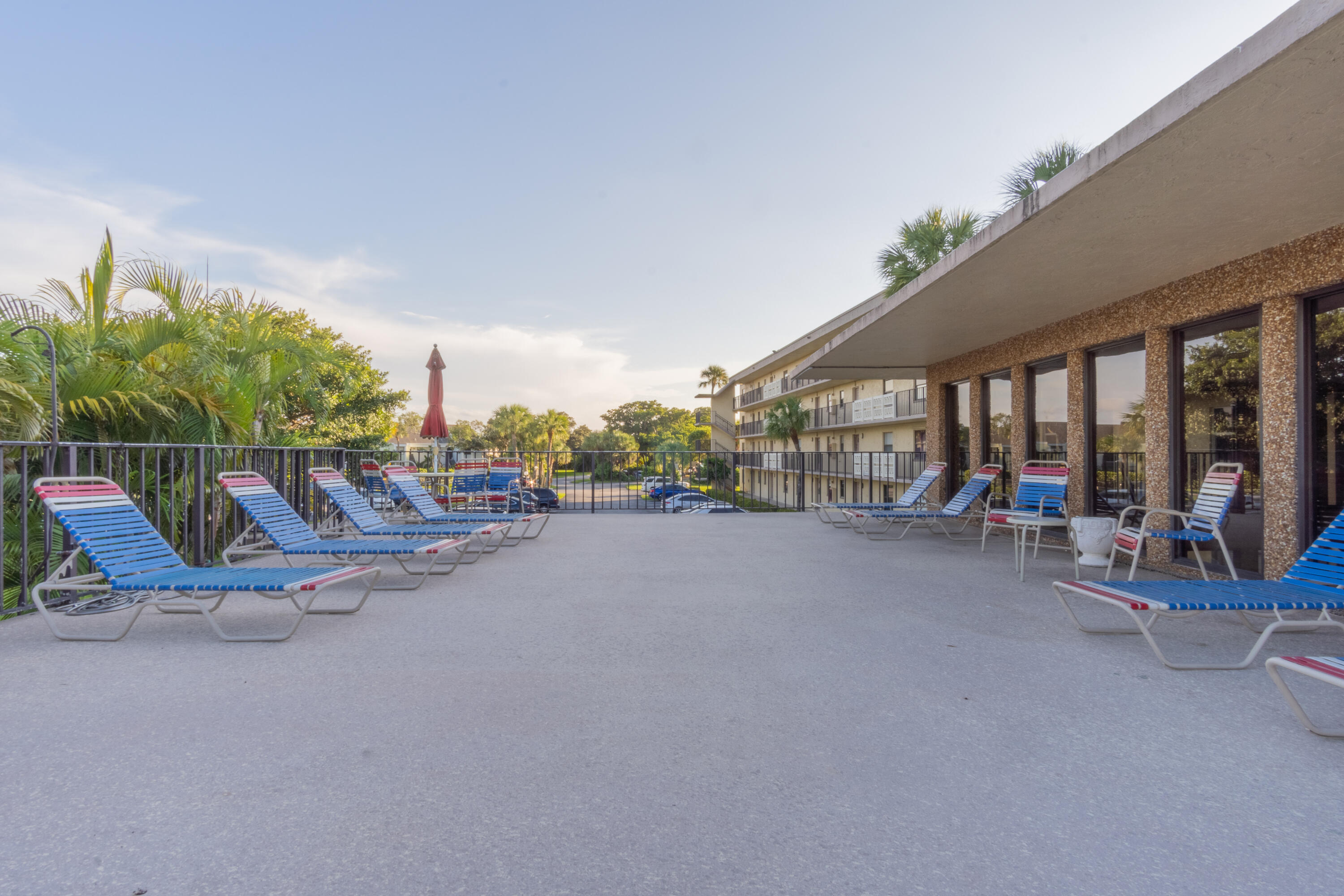 9355 Southwest 8th Street, Unit 406 Boca Raton, FL 33428 - Photo 19 of 22 a view of a patio with swimming pool