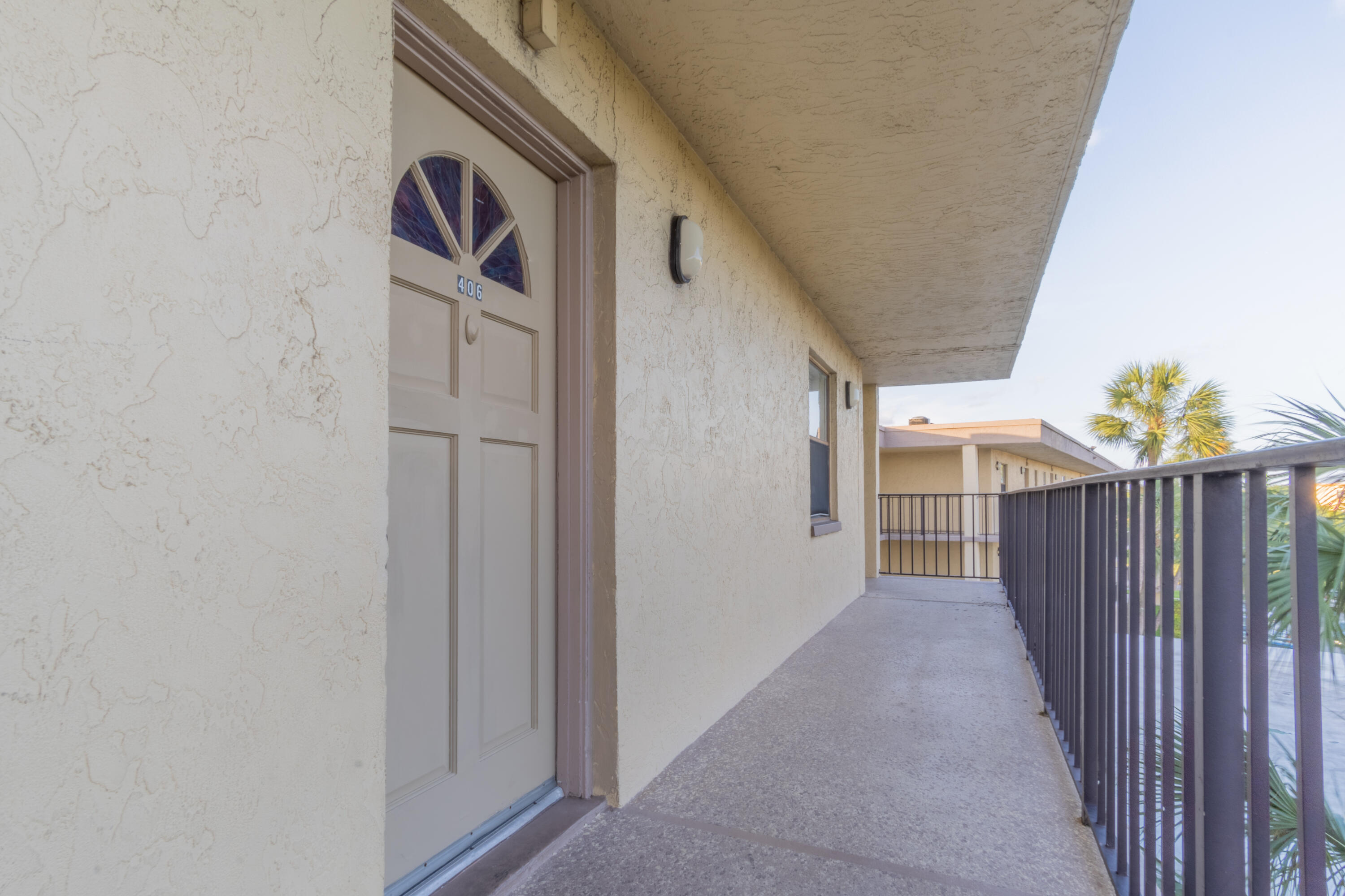 9355 Southwest 8th Street, Unit 406 Boca Raton, FL 33428 - Photo 2 of 22 a view of a door and stairs