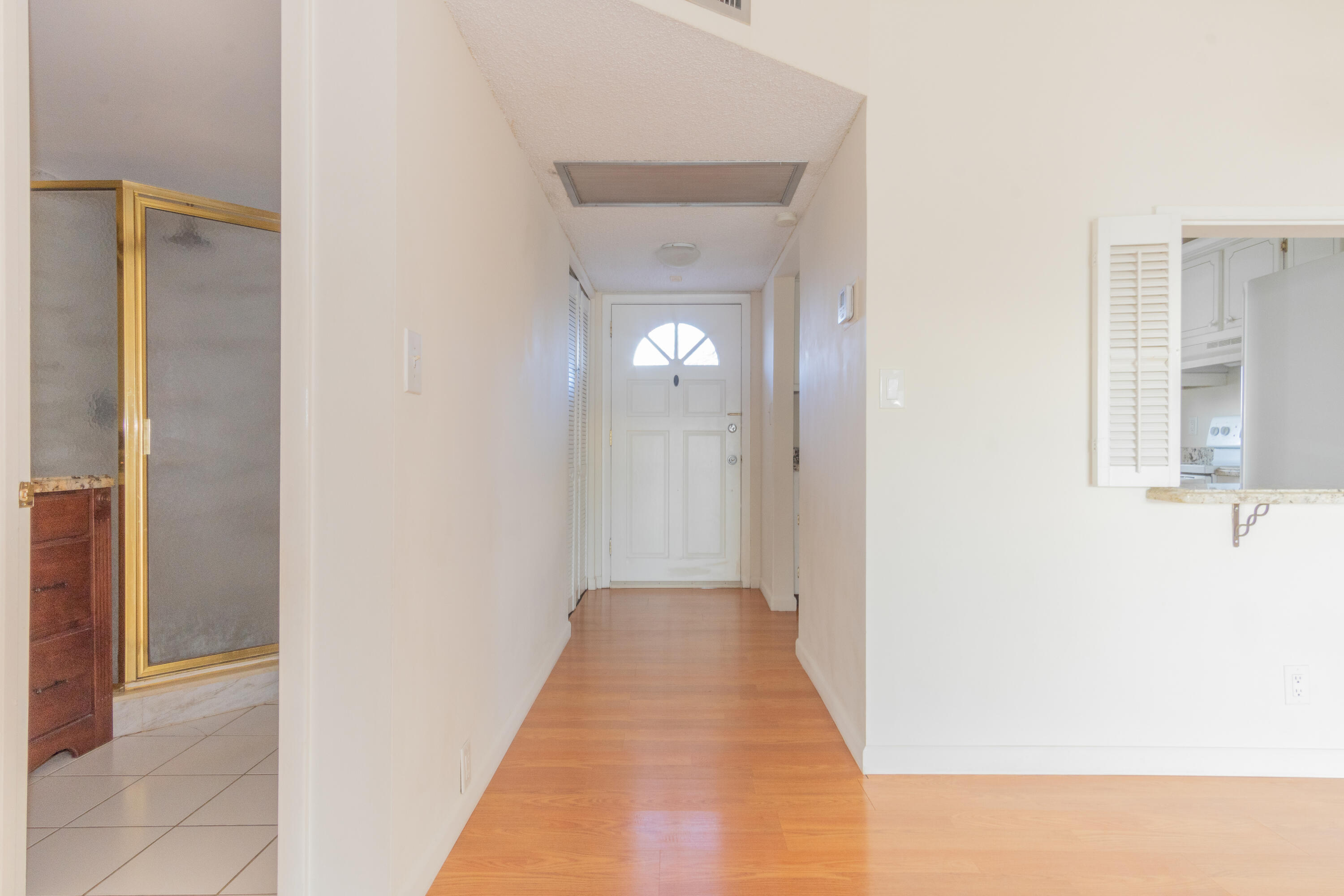 9355 Southwest 8th Street, Unit 406 Boca Raton, FL 33428 - Photo 3 of 22 a view of a hallway with wooden floor