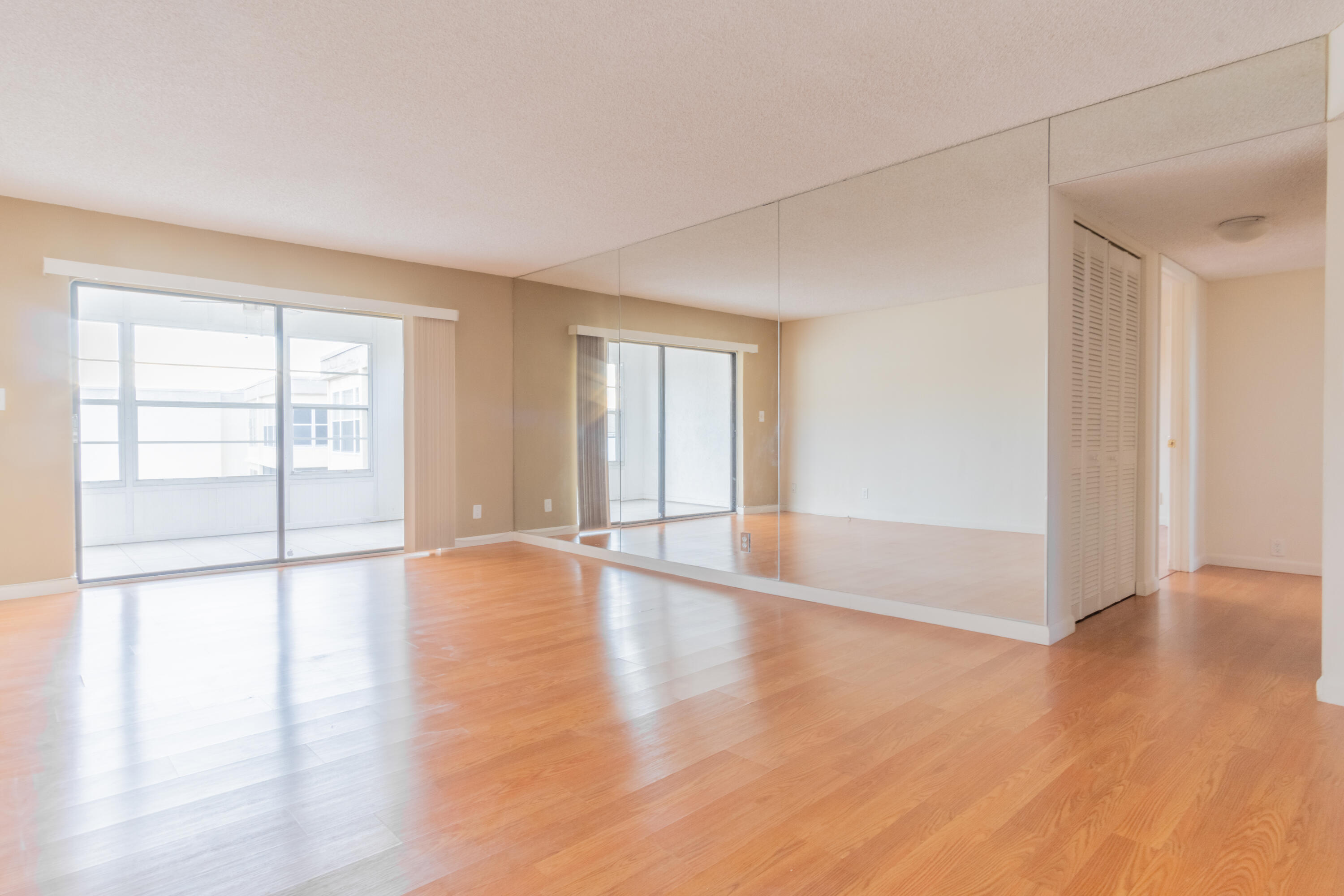 9355 Southwest 8th Street, Unit 406 Boca Raton, FL 33428 - Photo 6 of 22 an empty room with wooden floor and windows
