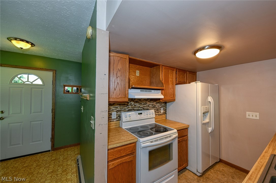 2715 Graham Road, Unit 4 Stow, OH 44224 - Photo 20 of 35 2715 Graham Rd #4, Stow, OH 44224 is an end unit condominium with 2 bedrooms, 1.5 bathrooms, 1 car garage, finished basement, laundry in lower level, huge side yard with pet fence & 3 collars provided, open floor plan from galley kitchen with oak cabinets & appliances to the large living room with wood burning fireplace, sliding glass doors to rear deck and sitting porch up front.
