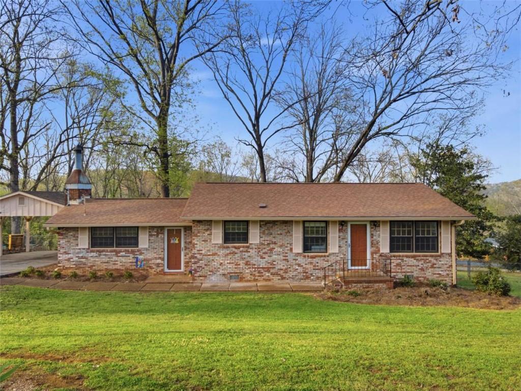 41 Summit Drive Lindale, GA 30147 - Photo 1 of 1 a front view of a house with a garden