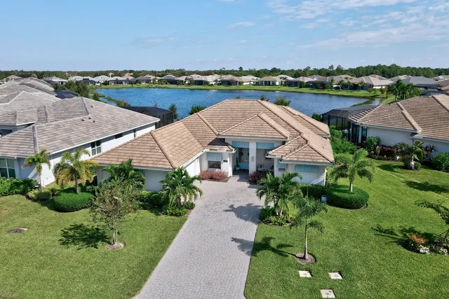 an aerial view of a house with garden space and lake view