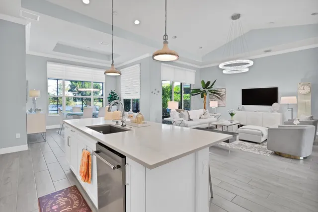 a kitchen with a sink and wooden floor