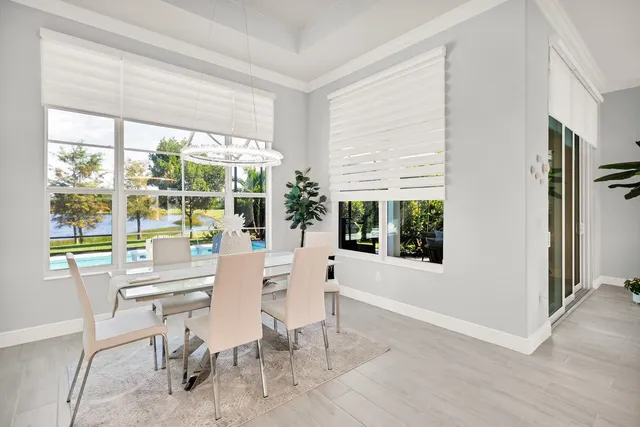 a dining room with furniture window outside view and wooden floor
