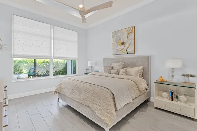 a bedroom with a bed painting and window