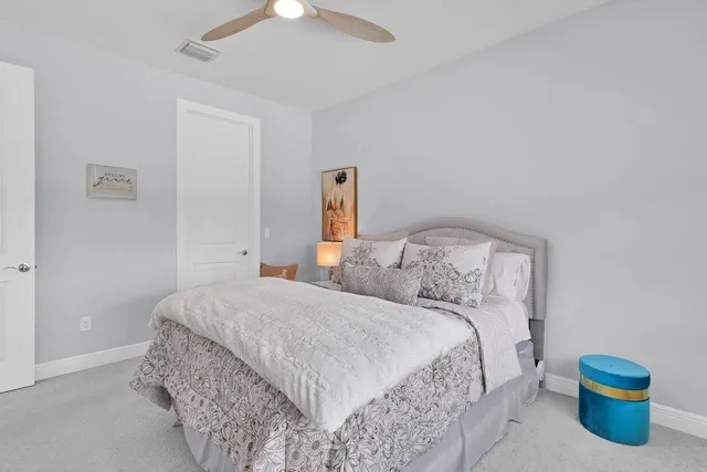 a bedroom with a bed and a potted plant