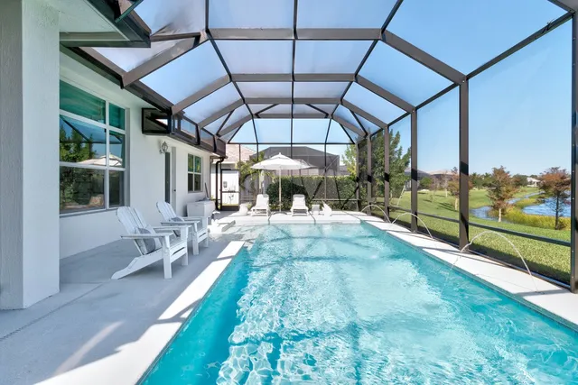 a view of a porch with furniture and a yard