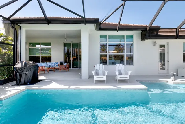a view of a house with backyard porch and sitting area