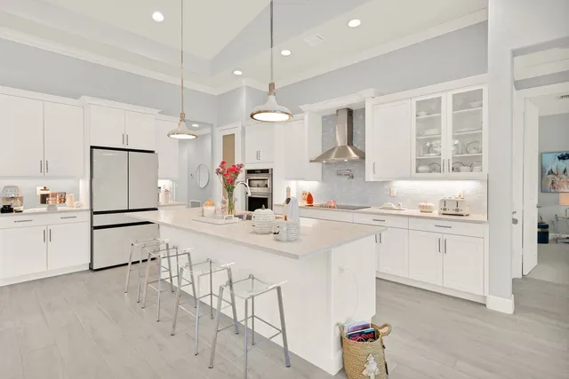 a kitchen with white cabinets and white appliances