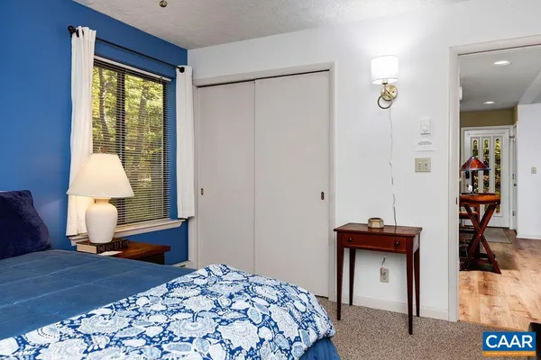 a bedroom with a bed and a lamp