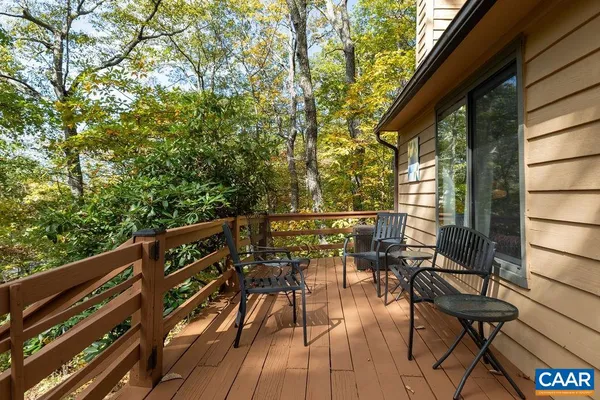 a view of balcony with chairs and wooden fence