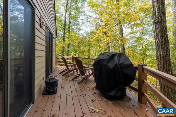 a view of balcony with wooden floor and outdoor seating