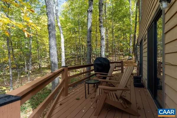 a view of balcony with chairs and wooden fence