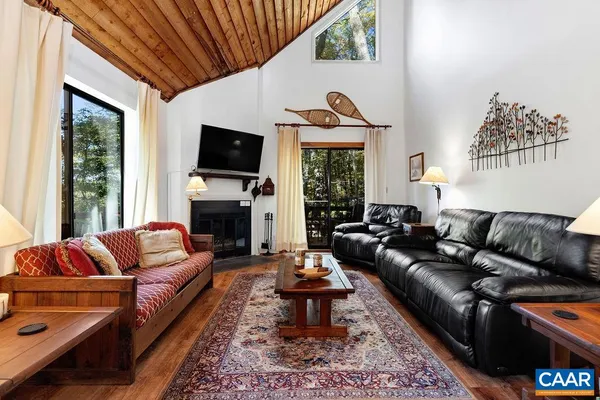 a living room with furniture fireplace and flat screen tv