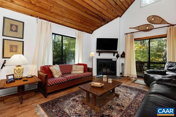 a living room with furniture fireplace and a flat screen tv
