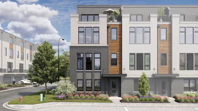 a front view of a residential apartment building with a yard