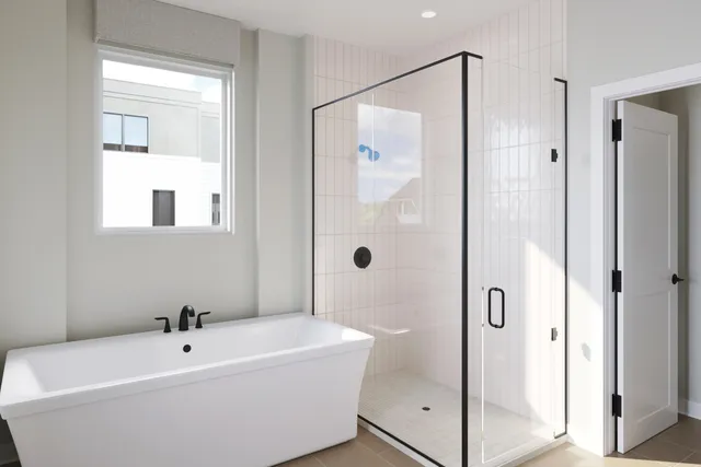 a bathroom with a bathtub and shower